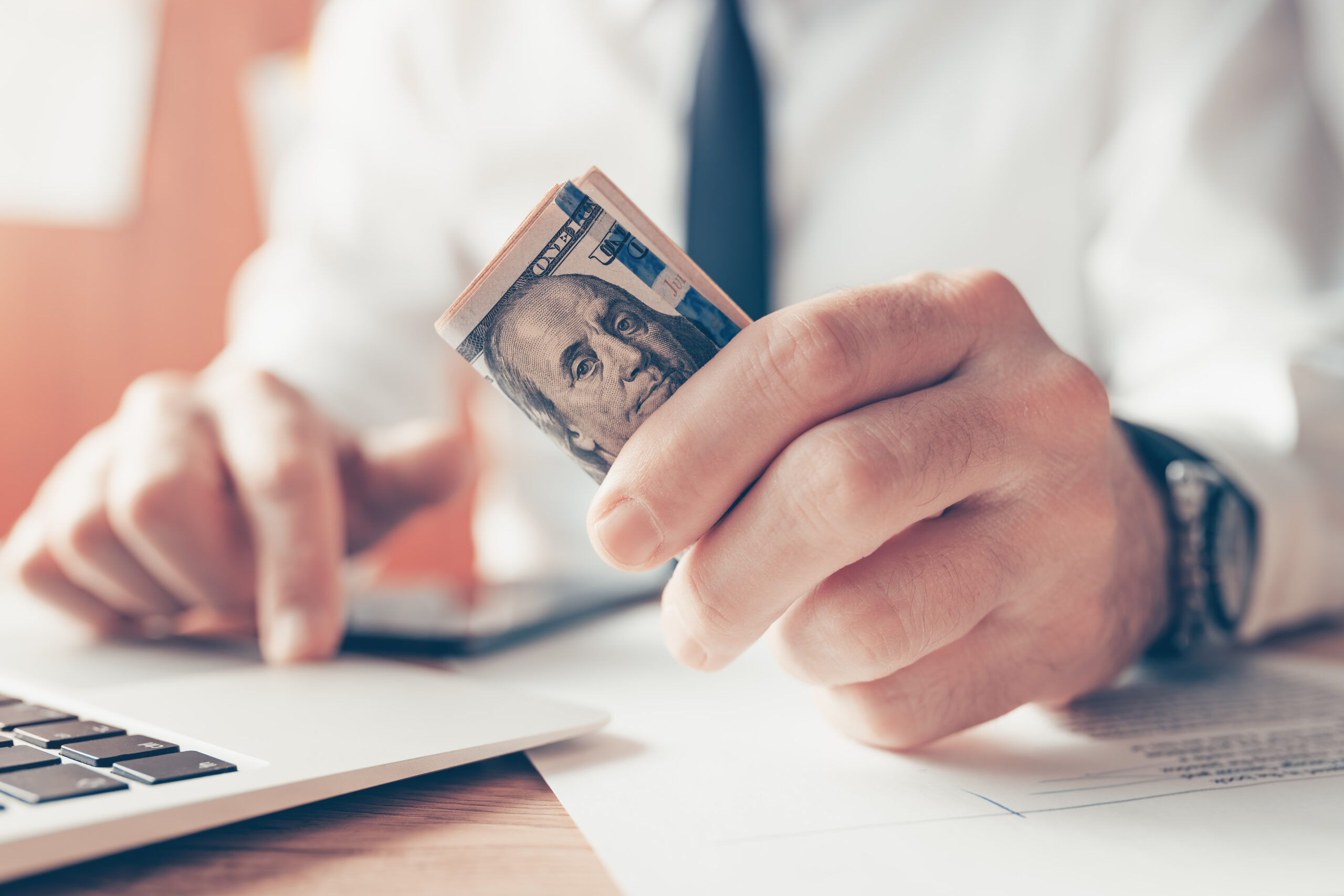 Businessman holding US dollars