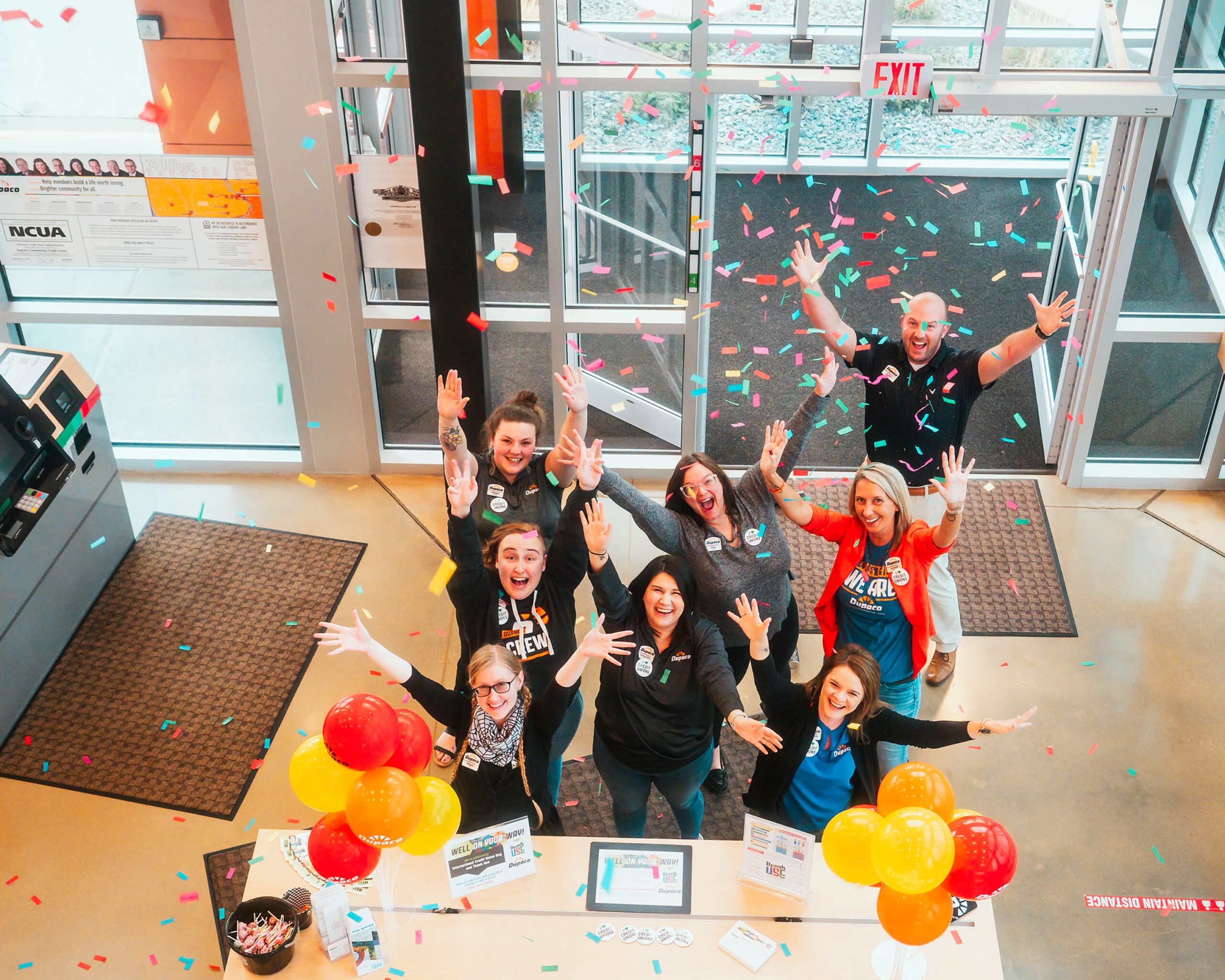 A group of professionals celebrating in a conference room, filled with enthusiasm and a sense of accomplishment among them.